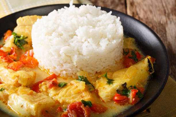 istock Fish stew in coconut milk with vegetables and rice close-up. horizontal 1049403150
