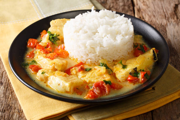 Ecuadorian cuisine: Pescado encocado or fish with coconut sauce close-up. Horizontal