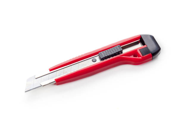 istock Red paper knife isolated on white background 1049403344