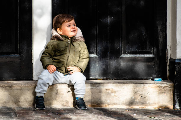 istock Baby boy wearing an army green coat 1049403722