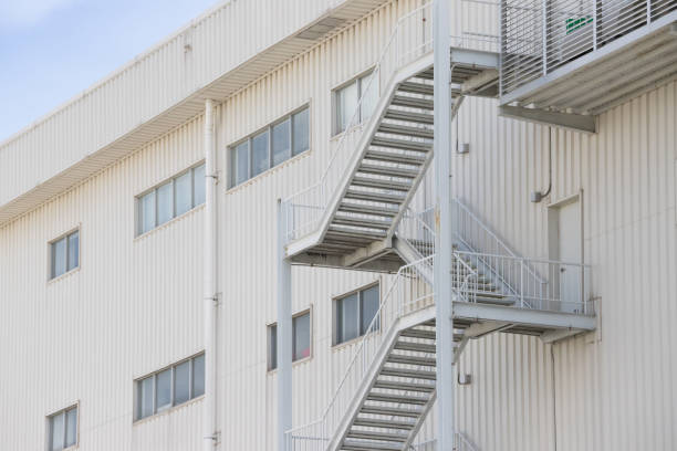istock fire exit steel stair outside of the building factory. 1049406596