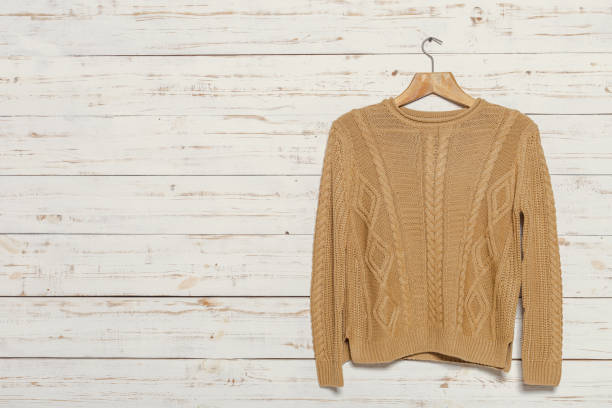istock knitted sweater on wooden clothes rack 1049407244