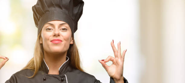 istock Young cook woman doing ok sign gesture with both hands expressing meditation and relaxation 1049407582