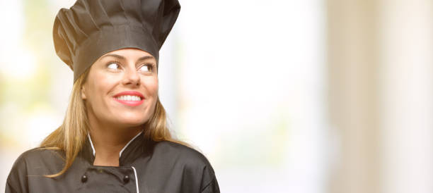 Young cook woman thinking and looking up expressing doubt and wonder