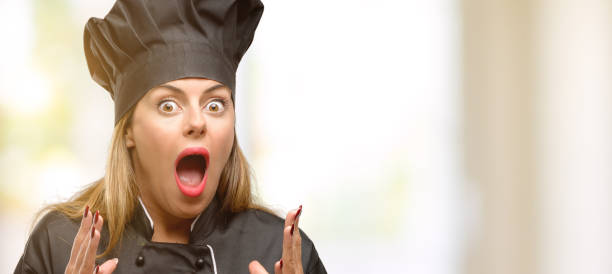 istock Young cook woman stressful keeping hands on head, terrified in panic, shouting 1049407662