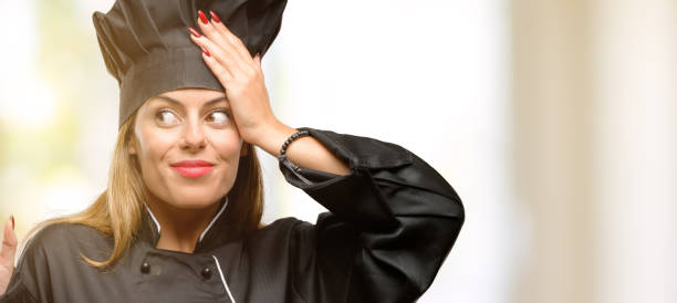 istock Young cook woman pointing away side with finger 1049407670