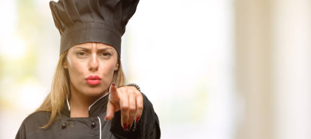 istock Young cook woman pointing to the front with finger 1049407672