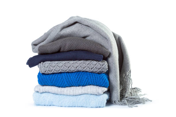 stack of various sweaters isolated on white background - monte roupa imagens e fotografias de stock