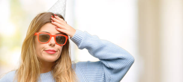 Young woman celebrates birthday doubt expression, confuse and wonder concept, uncertain future