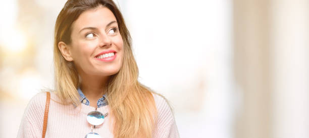 Young trendy woman thinking and looking up expressing doubt and wonder