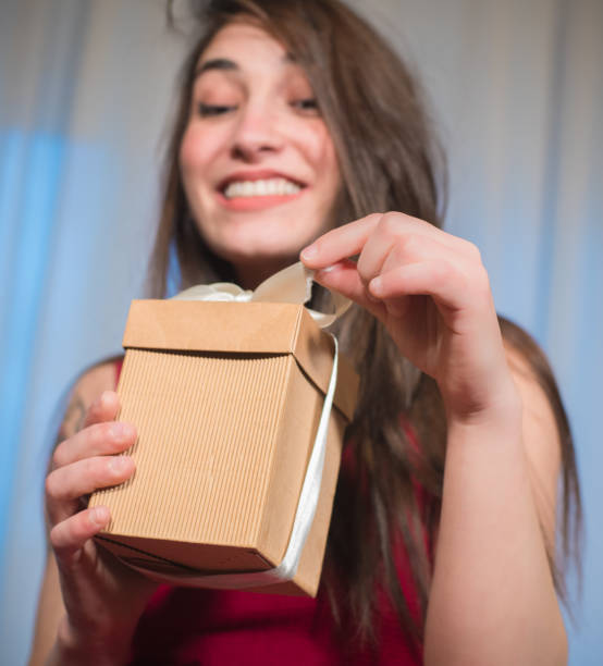 istock Gift box opening in happy woman hands 1049408022