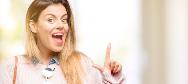 istock Young trendy woman pointing away side with finger 1049408058