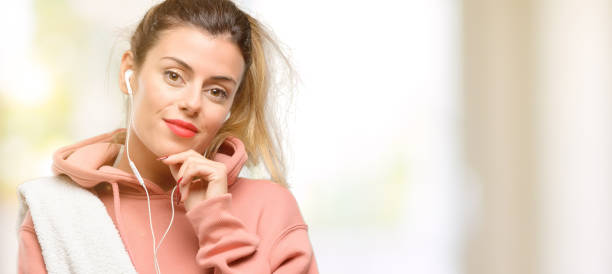 Young sport woman wearing workout sweatshirt thinking and looking up expressing doubt and wonder