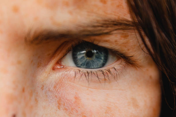 Beautiful Blue Eyes Close up shot of a woman's blue eye. squint eyes stock pictures, royalty-free photos & images
