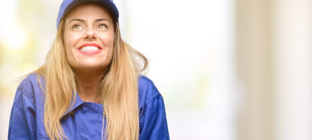 istock Young plumber woman thinking and looking up expressing doubt and wonder 1049410900