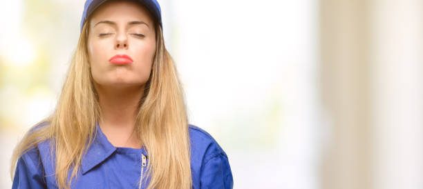 istock Young plumber woman with sleepy expression, being overworked and tired 1049410988