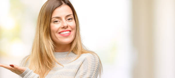 istock Young beautiful woman holding something in empty hand 1049411170