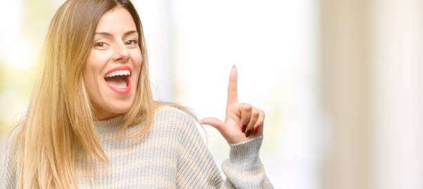 istock Young beautiful woman pointing away side with finger 1049411258