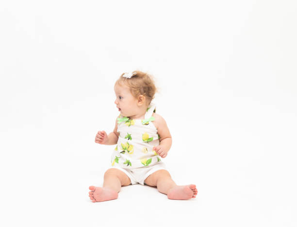 istock Happy baby boy is sitting on white background 1049411744