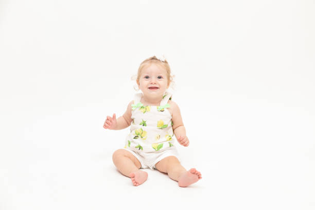 istock Happy baby boy is sitting on white background 1049412134