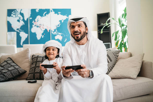 istock Arab dad and son playing with video games at home 1049414760