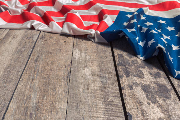 istock An American Flag Lying on an aged, weathered rustic wooden background 1049415654