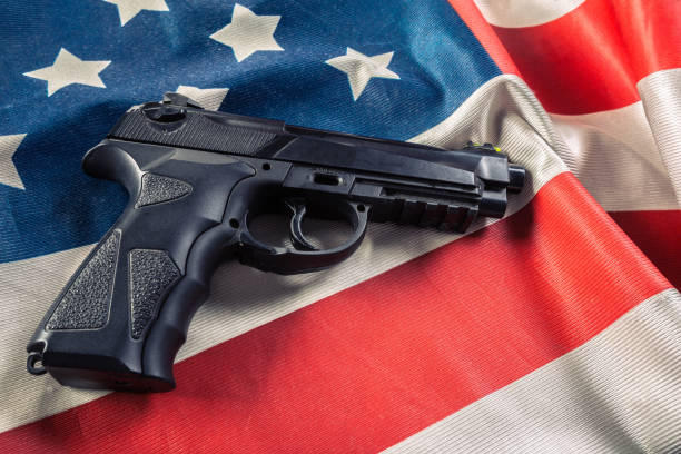 istock Handgun lying on American flag 1049415986
