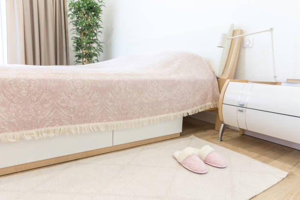 istock Bedroom in modern style with pink cozy soft slippers on floor 1049422408