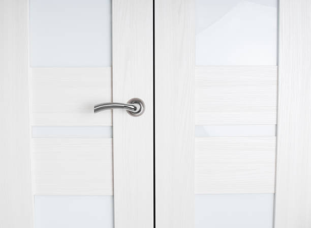 istock Metallic door handle on a wooden door 1049423096