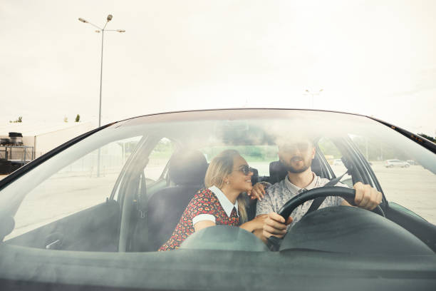 istock Happy casual couple having a conversation while driving a car. 1049425942