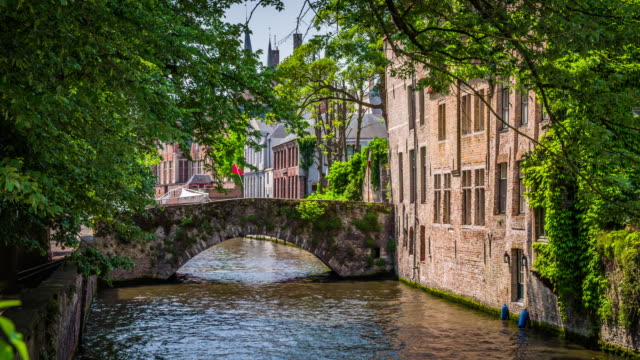 Vintage stone bridge over a canal in Bruges, Belgium