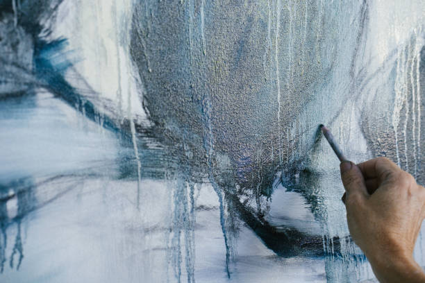istock Woman painting canvas in art studio 1049438010