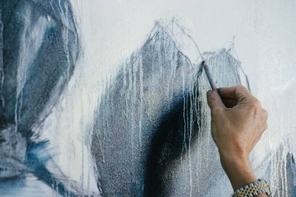 istock Woman painting canvas in art studio 1049438132