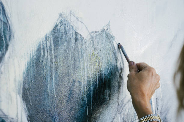 istock Woman painting canvas in art studio 1049447226