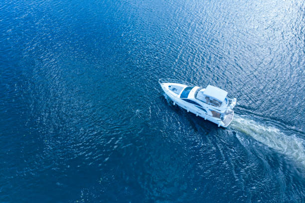 istock Motorboat racing through the river in sunlight. Top view 1049449612