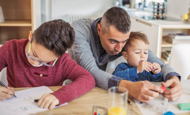 istock Father and sons at home 1049450926