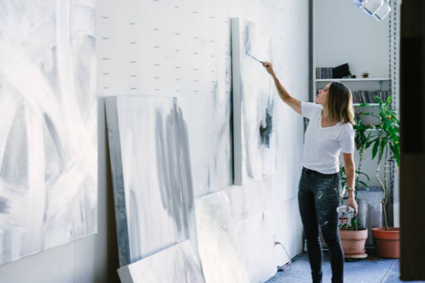 istock Woman painting canvas in art studio 1049450978