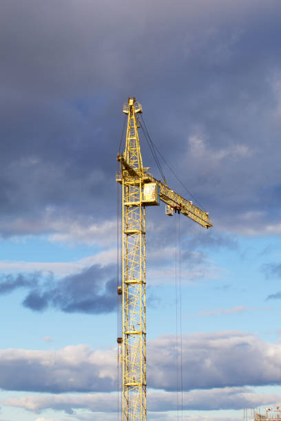 istock Yellow tower crane against the blue sky. 1049451072