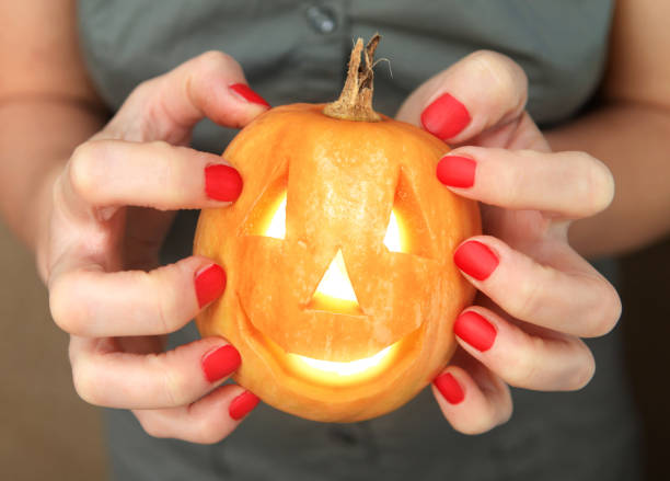 istock small yellow pumpkin in hands 1049454336