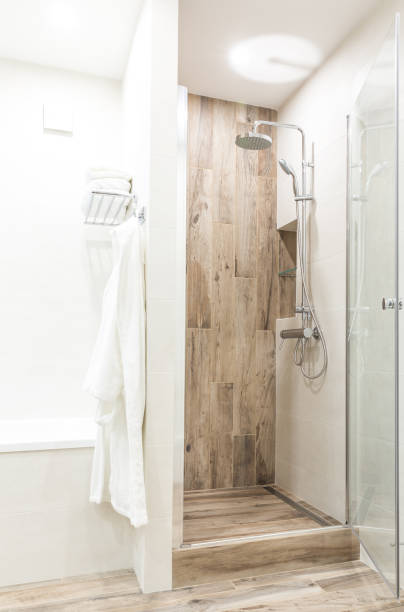 istock Walk in shower in bathroom with wooden style tile 1049458080