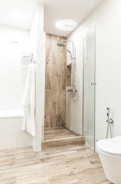 istock Walk in shower in bathroom with wooden style tile 1049458170