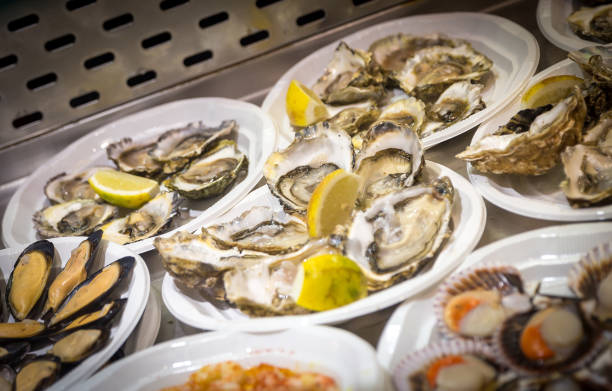 istock Oysters on plastic plates on seafood market 1049461240