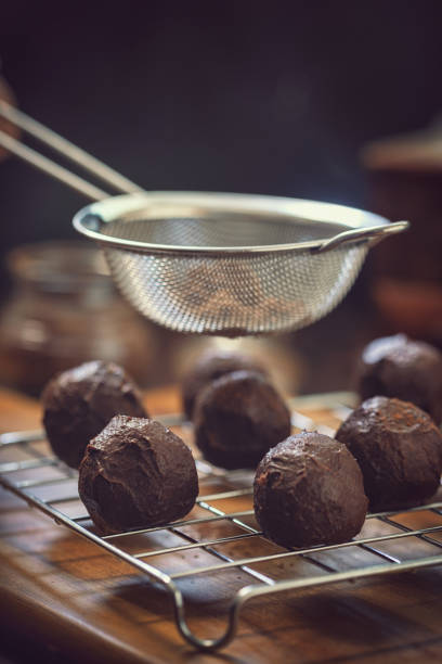 istock Young Woman Preparing Chocolate Truffles 1049465686