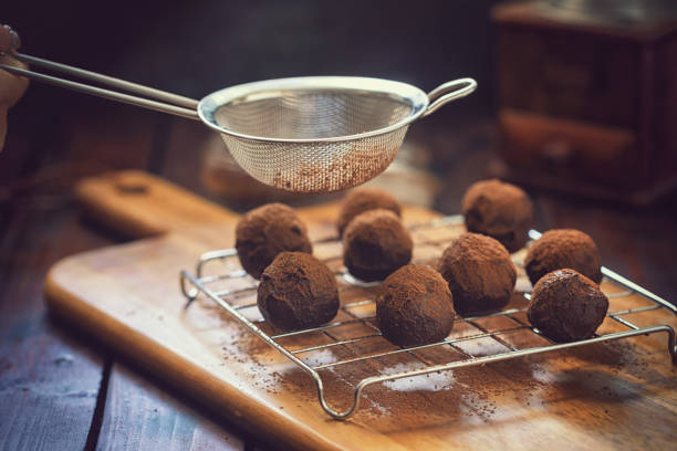 istock Young Woman Preparing Chocolate Truffles 1049465966