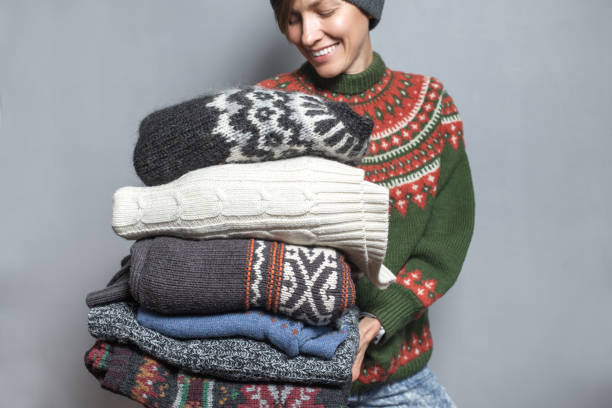 istock Autumn or winter young woman with knitted sweaters 1049468574