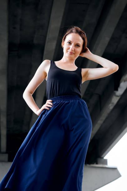 istock young girl posing under the bridge, dressed in black, modern architecture 1049469466