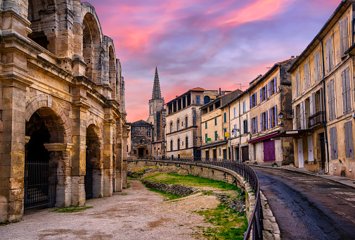 Arles Old Town and roman amphitheatre, Provence, France in dramatic sunset light