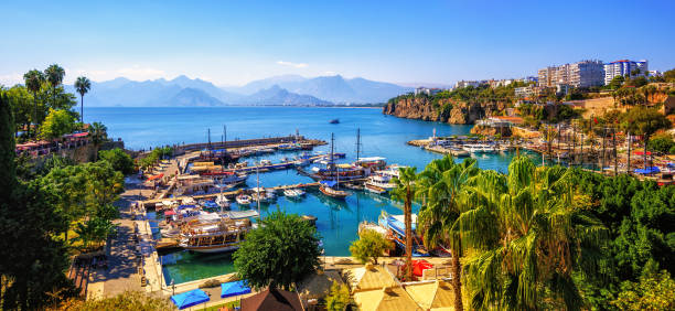 Panorama of the Antalya Old Town port, Turkey Panoramic view of Antalya Old Town port, Taurus mountains and Mediterrranean Sea, Turkey taurus photos stock pictures, royalty-free photos & images