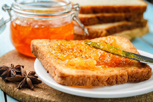 istock toasts with orange jam and knife 1049472656