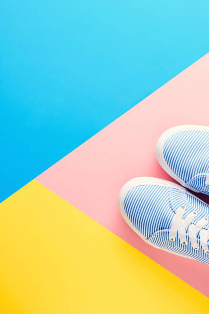 istock Blue striped sneakers on colored pastel background top view flat lay 1049472770